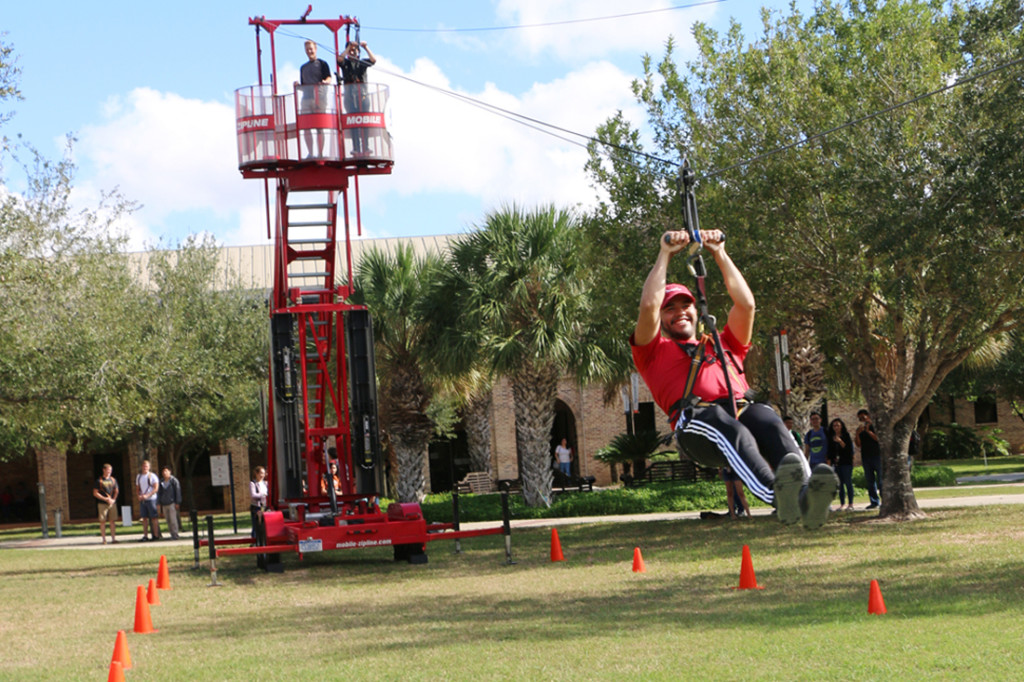 Biomedical sciences sophomore Rudy Garza rides along a zip line last Tuesday on the Student Union lawn in Brownsville. The ride was provided by the Campus Programming Board for students to enjoy./Ana Cahuiche/The Rider