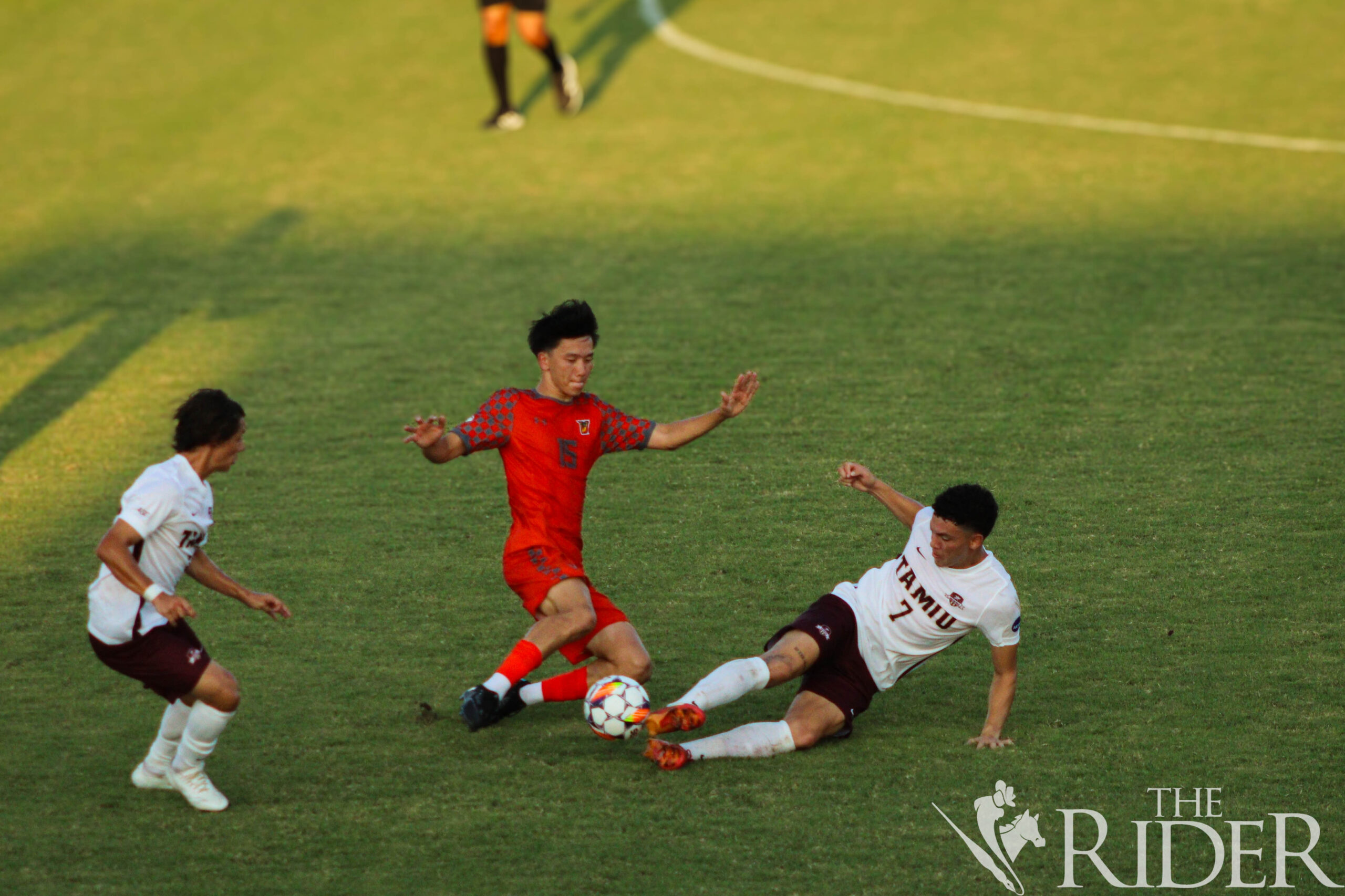 Vaquero junior defender Shuntaro Endo and a TAMIU opponent slide to block the ball during tonight’s exhibition match at the UTRGV Soccer and Track & Field Complex on the Edinburg campus. The Vaqueros won against the Dust Devils 3-2. Abigail Ollave/THE RIDER