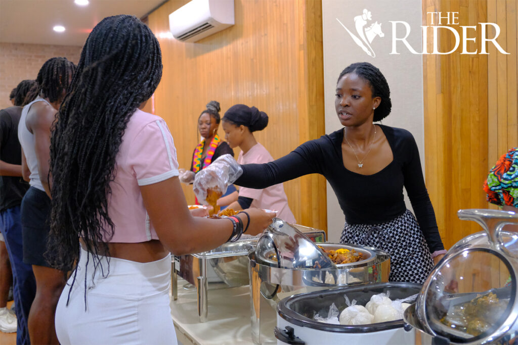 Ewuradwoa Nketiah, an ASA member (right), serves chicken to biomedical science junior Lani Brewer during the ASA Fall Social 2024 Saturday in the University Ballroom on the Edinburg campus. Angel Ballesteros/THE RIDER