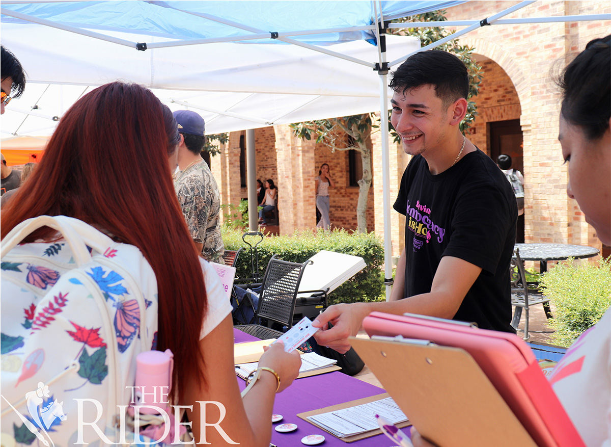 Biology junior Jose Perez, a NextGen America member, helps students register to vote Aug. 27 at the Get Involved Fair in the Main Courtyard on the Brownsville campus. Venisha Colón/THE RIDER PHOTOS