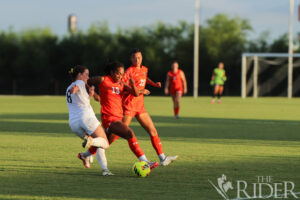 Vaqueros freshman forward Krystin Moore pushes through to block a kick by Yellow Jacket junior forward Hannah Noel during tonight’s match against Howard Payne University at the UTRGV Soccer and Track & Field Complex on the Edinburg campus. Also shown is Vaqueros junior forward Olivia Trotter. Abigail Ollave/THE RIDER