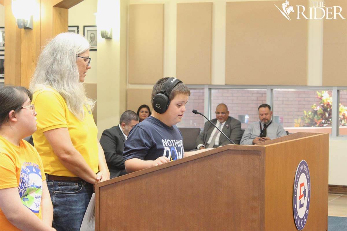 Ben Tomai invites city council members to the Step Up for Down Syndrome walk, which will take place Oct. 19. Also shown are his mother Deborah Tomai (center), president of the Rio Grande Valley Down Syndrome Association, and Esther Moran during Tuesday’s meeting. Raquel Cazares/THE RIDER