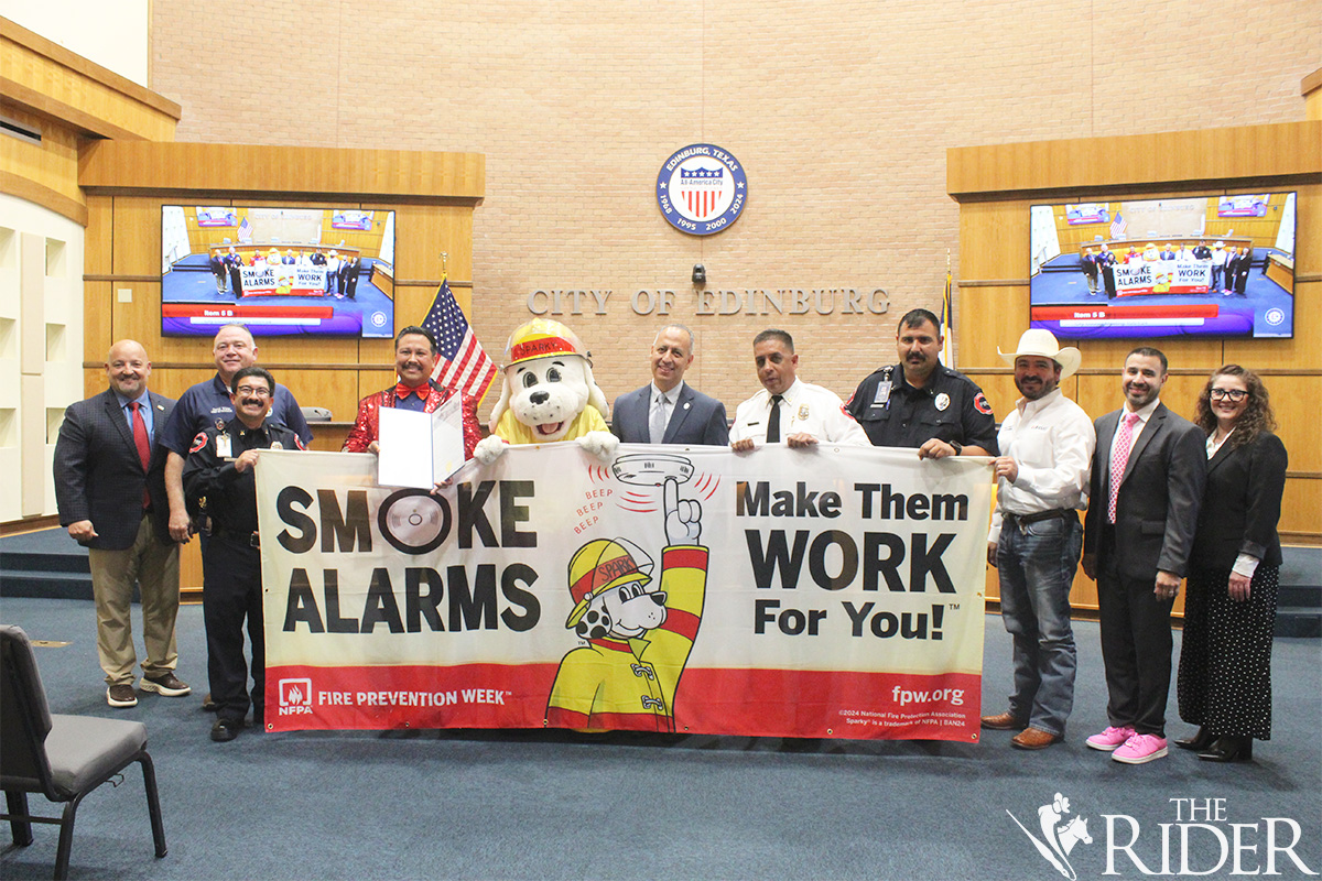 Members of the Edinburg Fire Department pose with the Edinburg City Council during Tuesday’s meeting after October was declared as Fire Safety Month. Shown are Mayor Pro Tem Daniel “Dan” Diaz (from left), Councilmember Place 4 David White, Fire Capt. Anthony Riojas, Lt. Adrian Cisneros as El Bob, Sparky, Mayor Ramiro Garza Jr., Fire Chief Omar Garza, Lt. Richard Trevino, Councilmember Place 3 David Salazar Jr., Councilmember Place 2 Jason De Leon and City Manager Myra Ayala. Raquel Cazares/THE RIDER