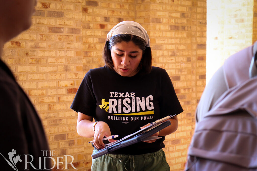 Public affairs graduate student Estrella Torres, the Texas Rising regional program coordinator, gathers voter registration applications Oct. 7 outside the University Library on the Brownsville campus. Venisha Col贸n/THE RIDER