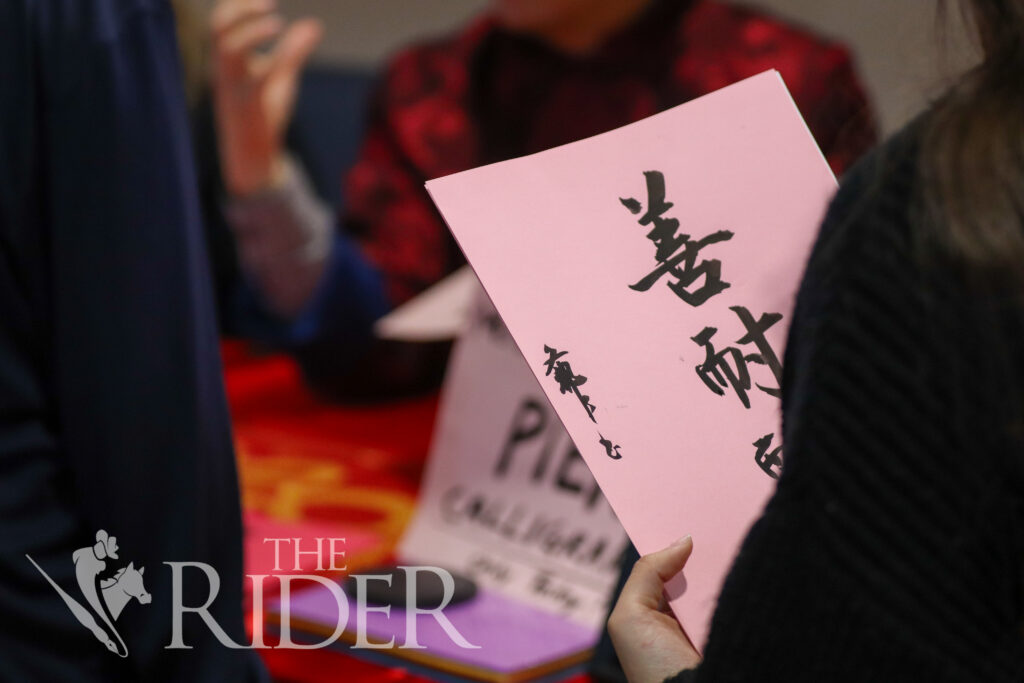 A student admires calligraphy painted by Pierre Lu, a UTRGV professor of research methodology. The celebration was hosted by International Student Services. Mykel Del Angel/THE RIDER