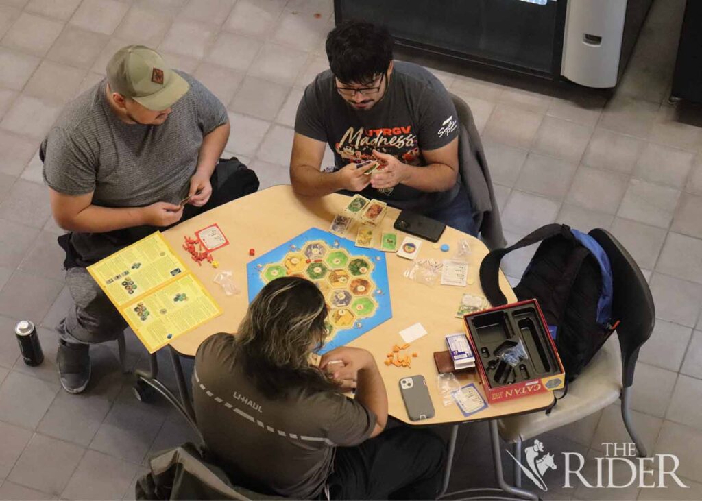 Psychology freshman Joseph Flores (from left), psychology sophomore Daniel Gonzalez and marine biology sophomore Jesse Gonzalez play Catan Wednesday in the Student Union on the Brownsville campus. Sofía Cantú Sauceda/ THE RIDER