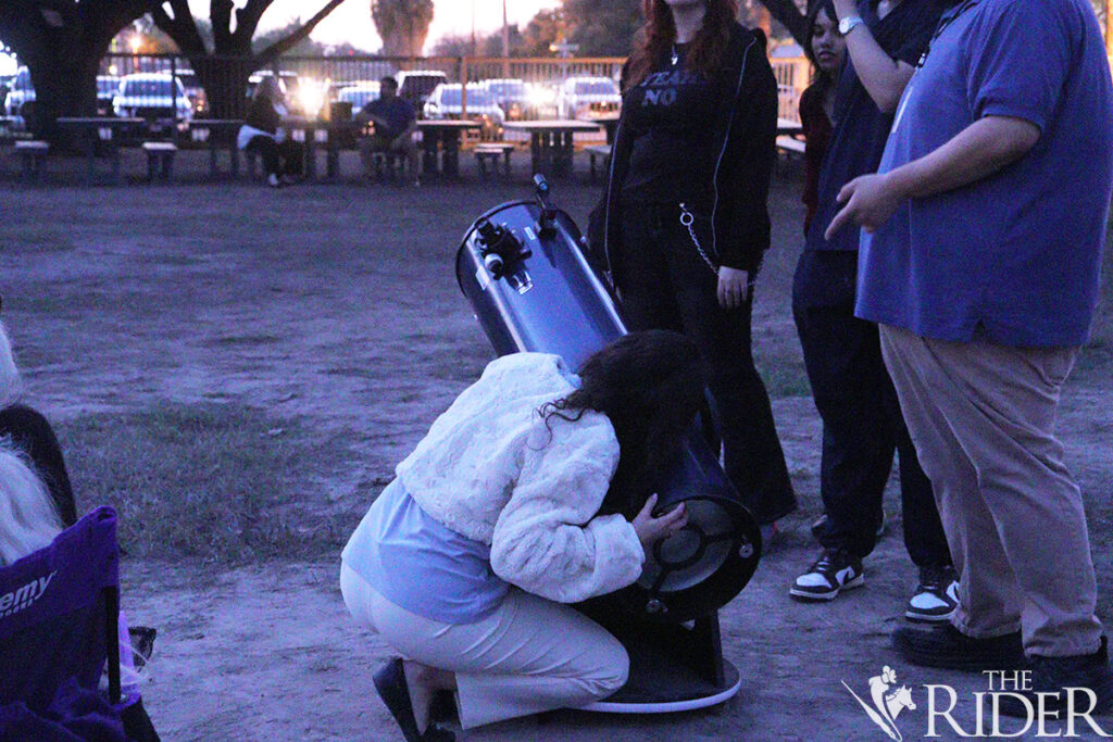 Accounting senior Darcy Rios calibrates Orion SkyQuest XT10 Plus telescope during the Mysterious Cosmos Family Fun Nights Thursday at the International Museum of Art & Science in McAllen. Amara Cazares/THE RIDER