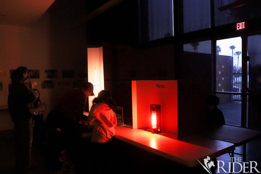 Attendees interact with a Spectroscopy activity during the Mysterious Cosmos Family Fun Nights Thursday at the International Museum of Art & Science in McAllen. Attendees solve the light wavelength omitted by each light in an activity Thursday during the Mysterious Cosmos Family Fun Nights at the International Museum of Art & Science in McAllen. Amara Cazares/THE RIDER