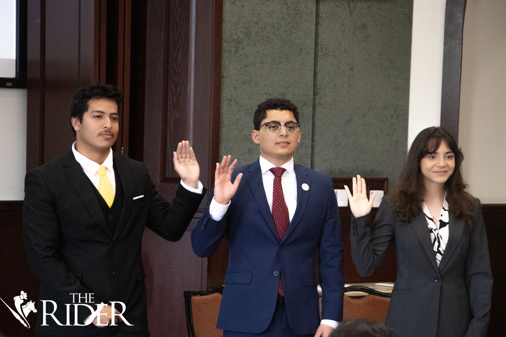 Kevin Flores (from left), Student Government Association external vice president; Ian Alfaro, SGA president; and Kayla Johnson, SGA internal vice president, raise their hands during the oath of office during the SGA inauguration Tuesday in Salón Cassia on the Brownsville campus 
Valeria Tokun 