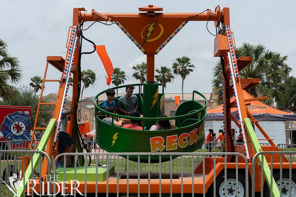 Students enjoy a carnival ride during the 10 Year Celebration Tuesday on the Main Building lawn on the Brownsville campus. Carnival rides were available to students during the event.