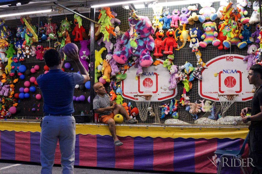 A student shoots a basketball, attempting to win a prize, during the 10 Year Celebration Thursday in Lot E-16 on the Edinburg campus.
